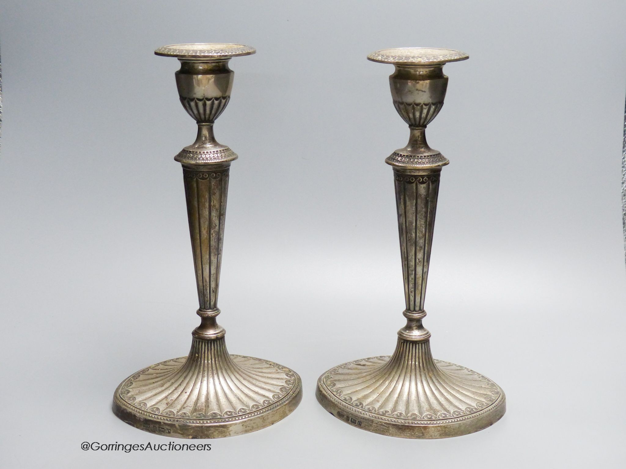 A pair of Edwardian silver candlesticks, by Elkington and co, Birmingham 1904, loaded, 28.5 cm high